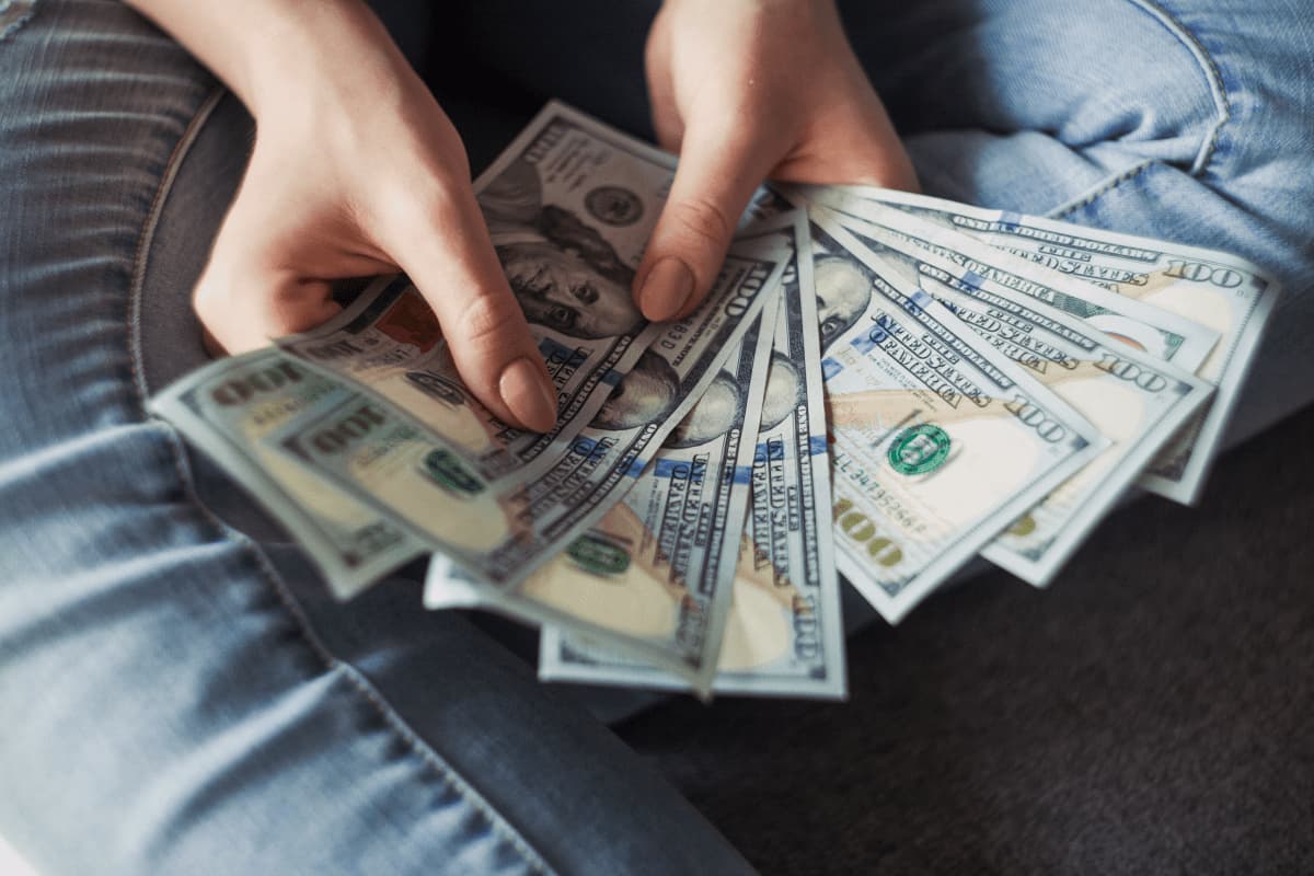 a woman holding money in their hands