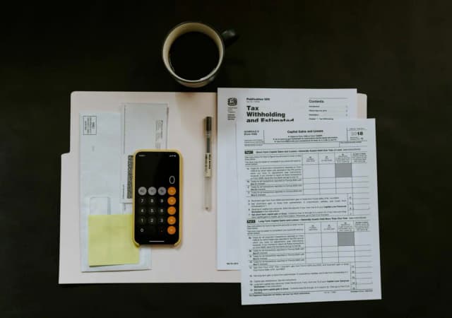 Desk with tax forms and calculator for financial planning