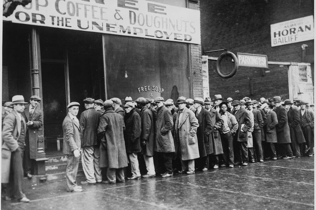 a group of men standing in a line outside a cafe