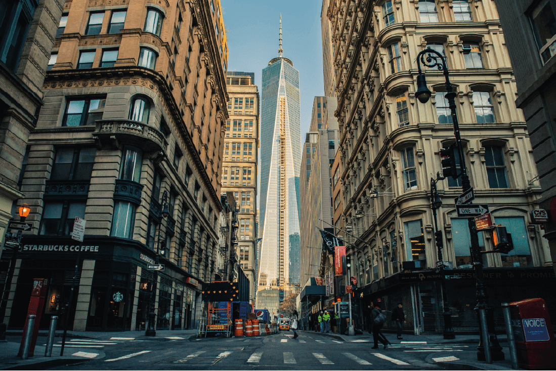 a street with tall buildings and people walking on it