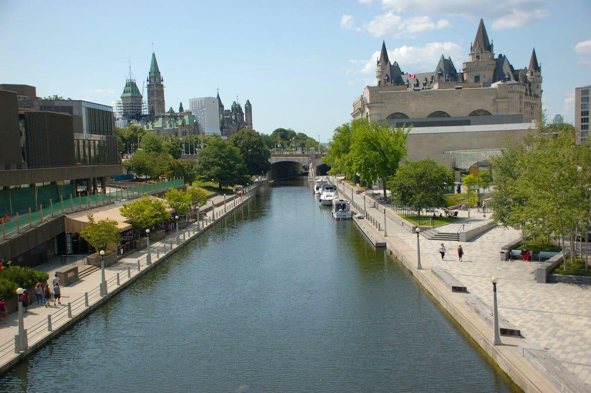 A picturesque canal with a charming bridge gracefully spanning its tranquil waters.