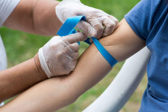 Doctor examining patient's arm for medical diagnosis