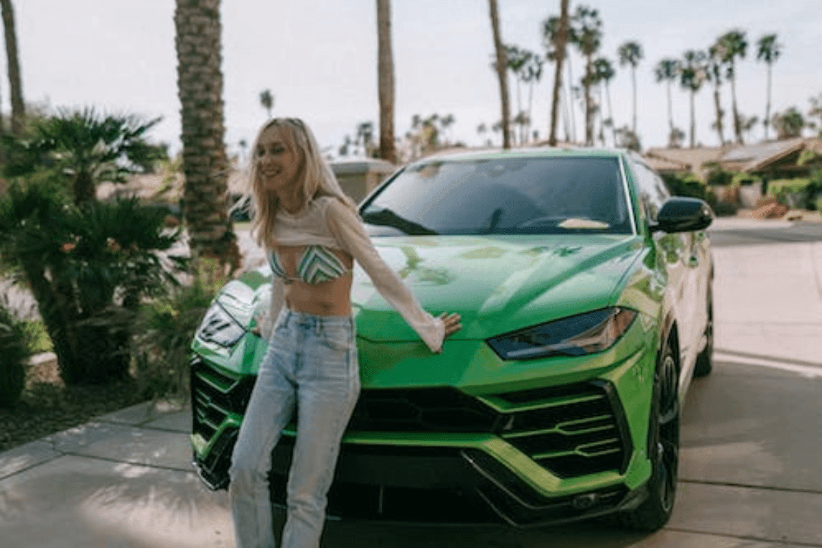 a person leaning on a green car