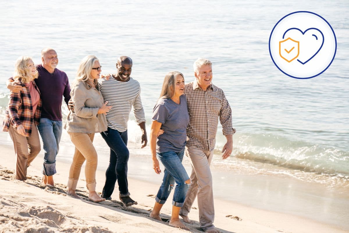 A group of people strolled on the beach, accompanied by the words "health care" written on the sand