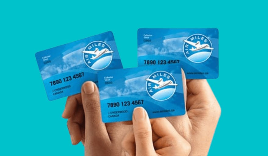 Three people holding blue credit cards