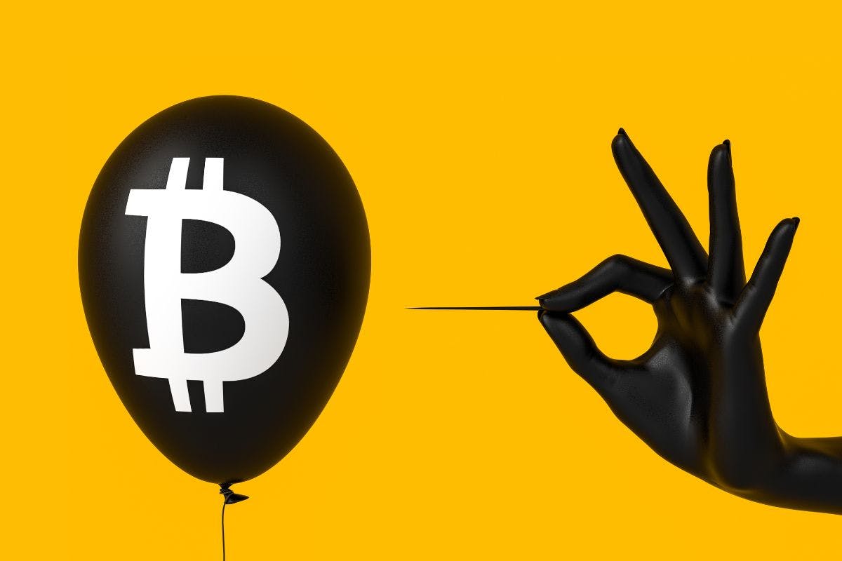 A hand holds a black balloon featuring a bitcoin symbol, representing the digital currency's rising popularity.