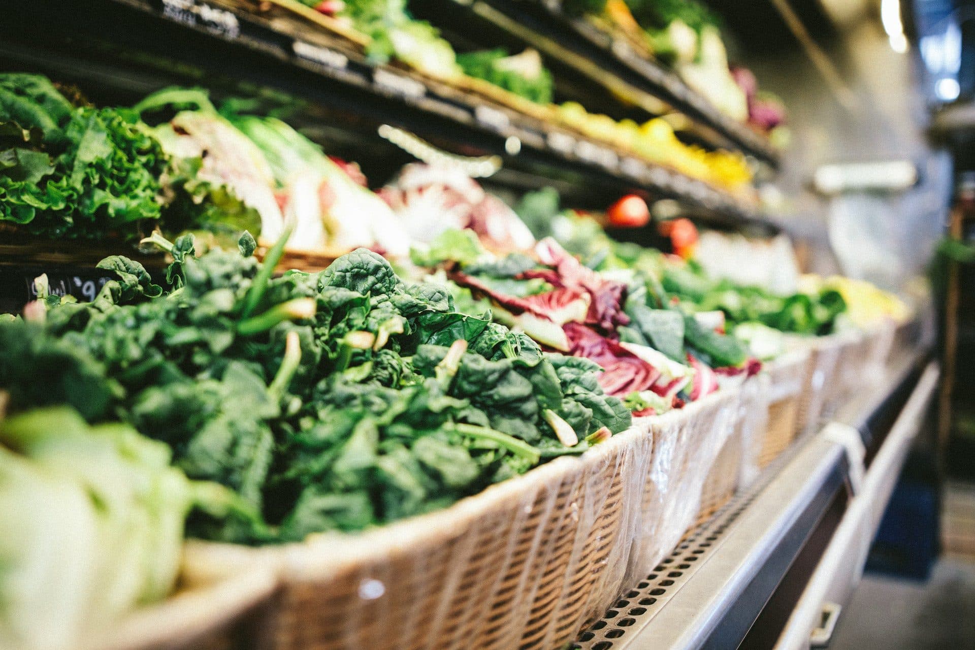 a basket of vegetables in a grocery store