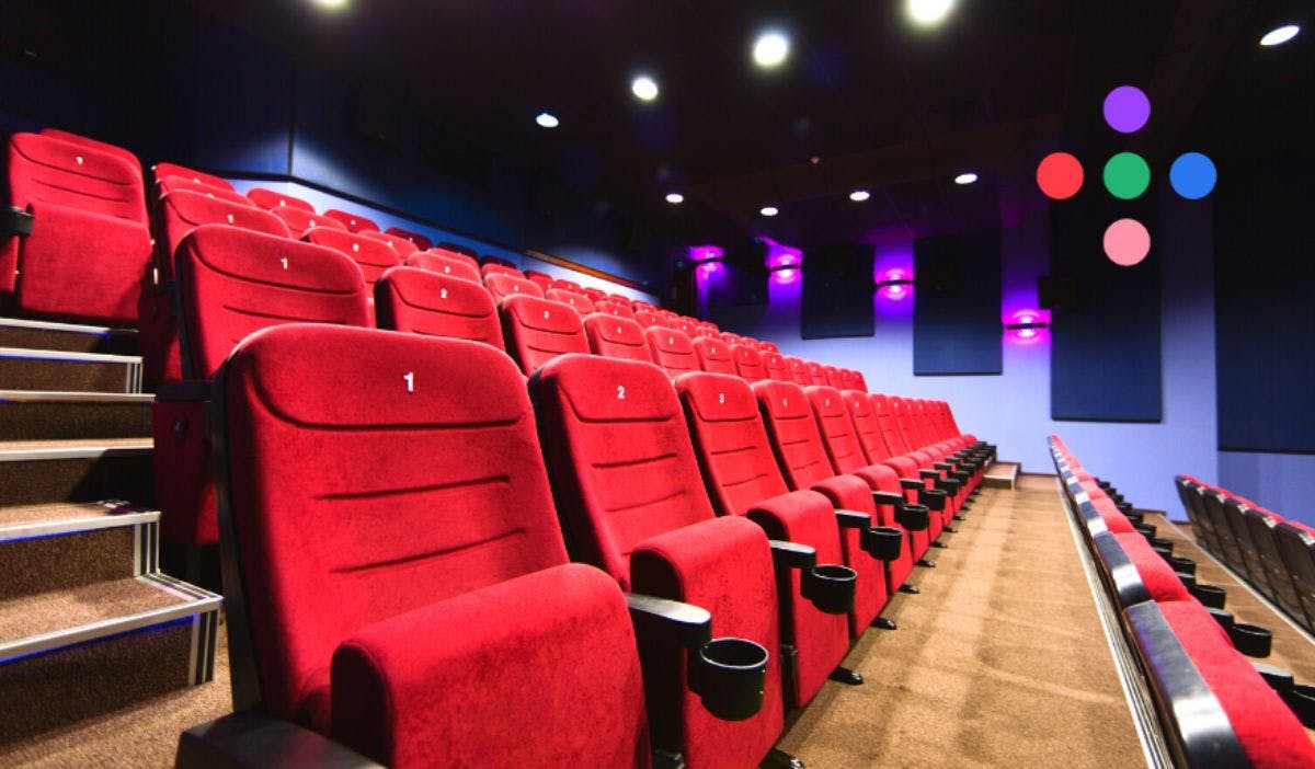 A row of red seats in a movie theater