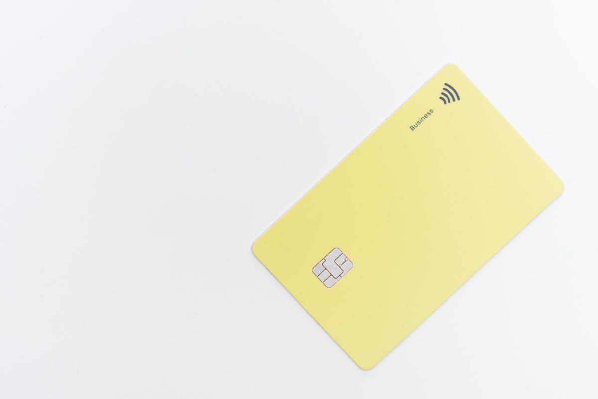 a yellow credit card with a chip