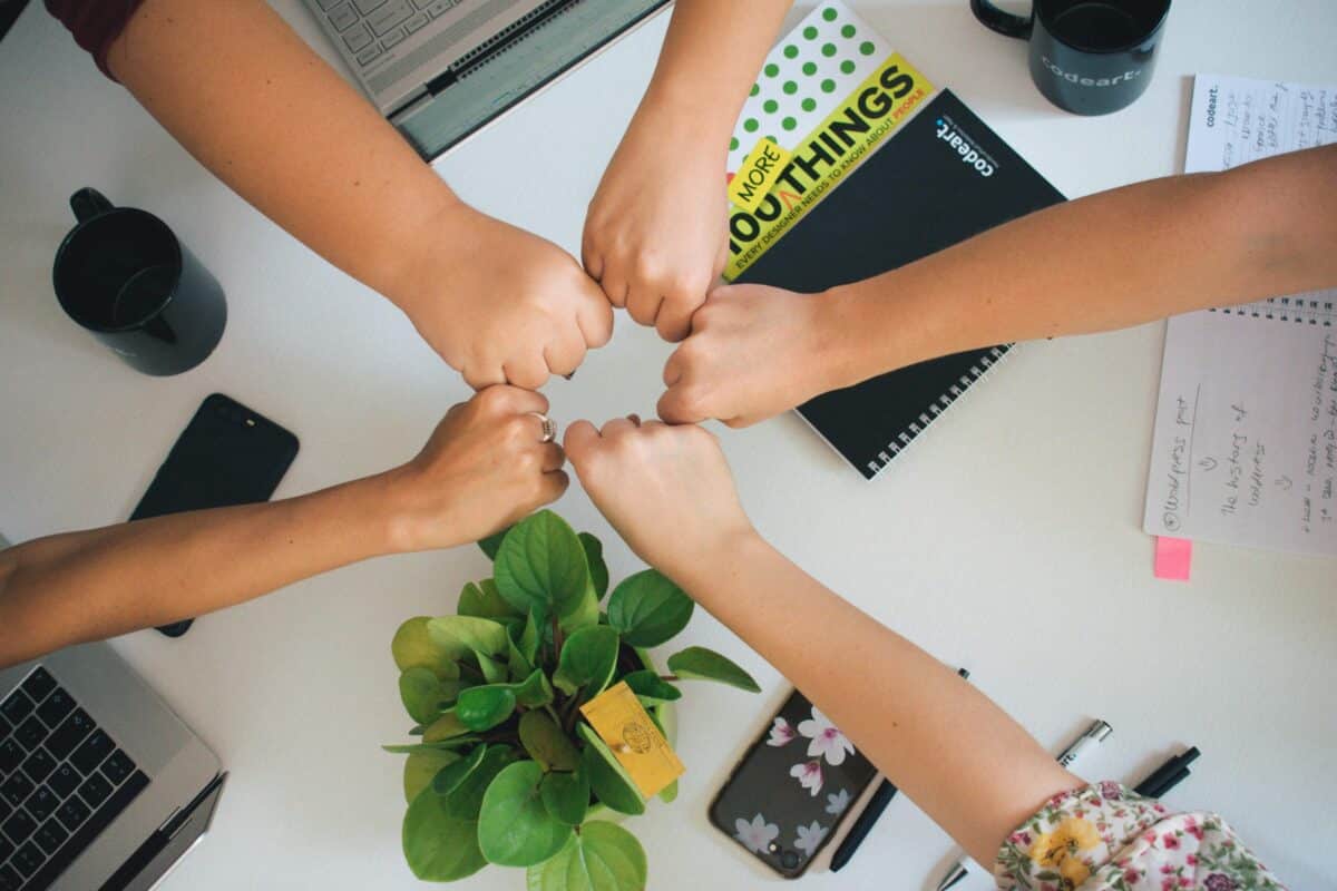 a group of people putting their fists together