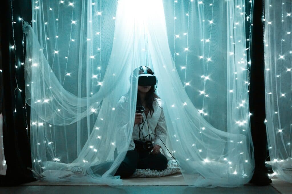 Serene woman on bed adorned with white lights.