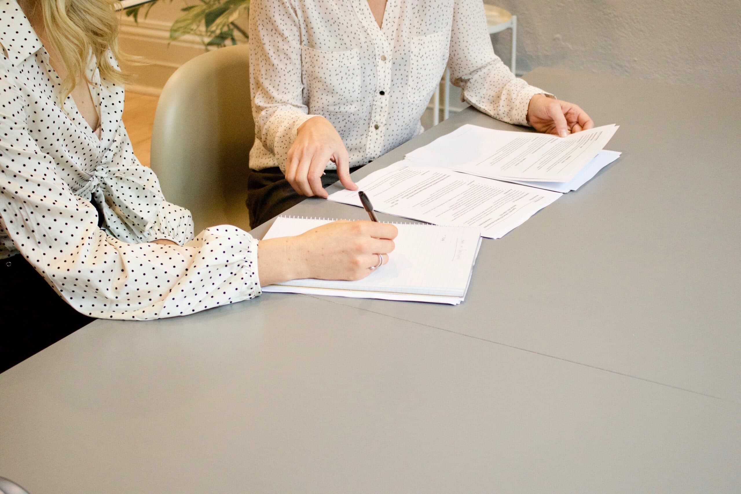 a person sitting at a table with papers on it