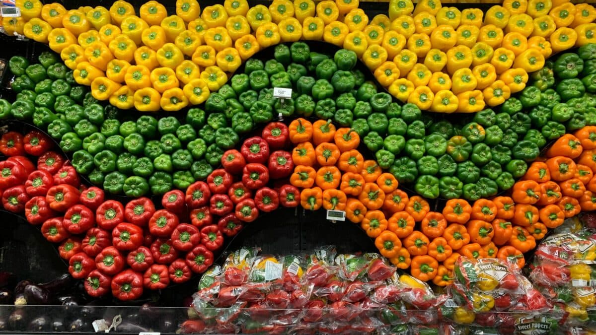 a display of peppers in different colors