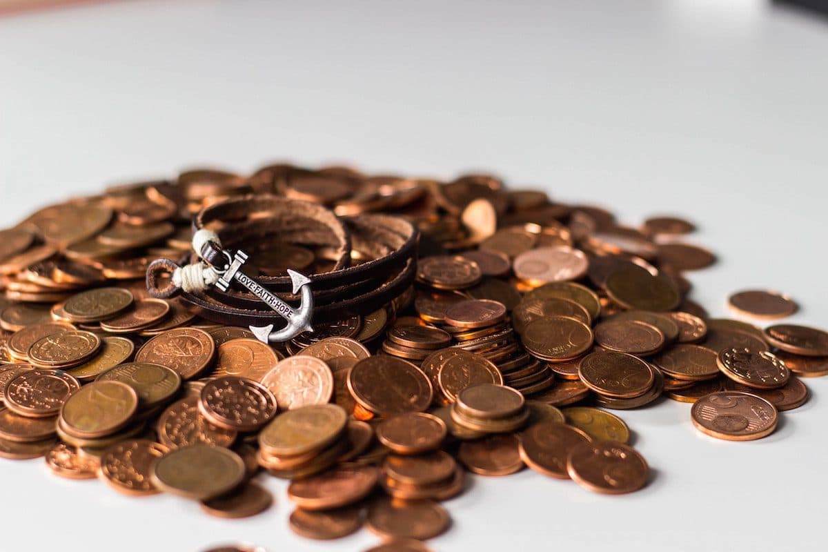 a bracelet on a pile of coins