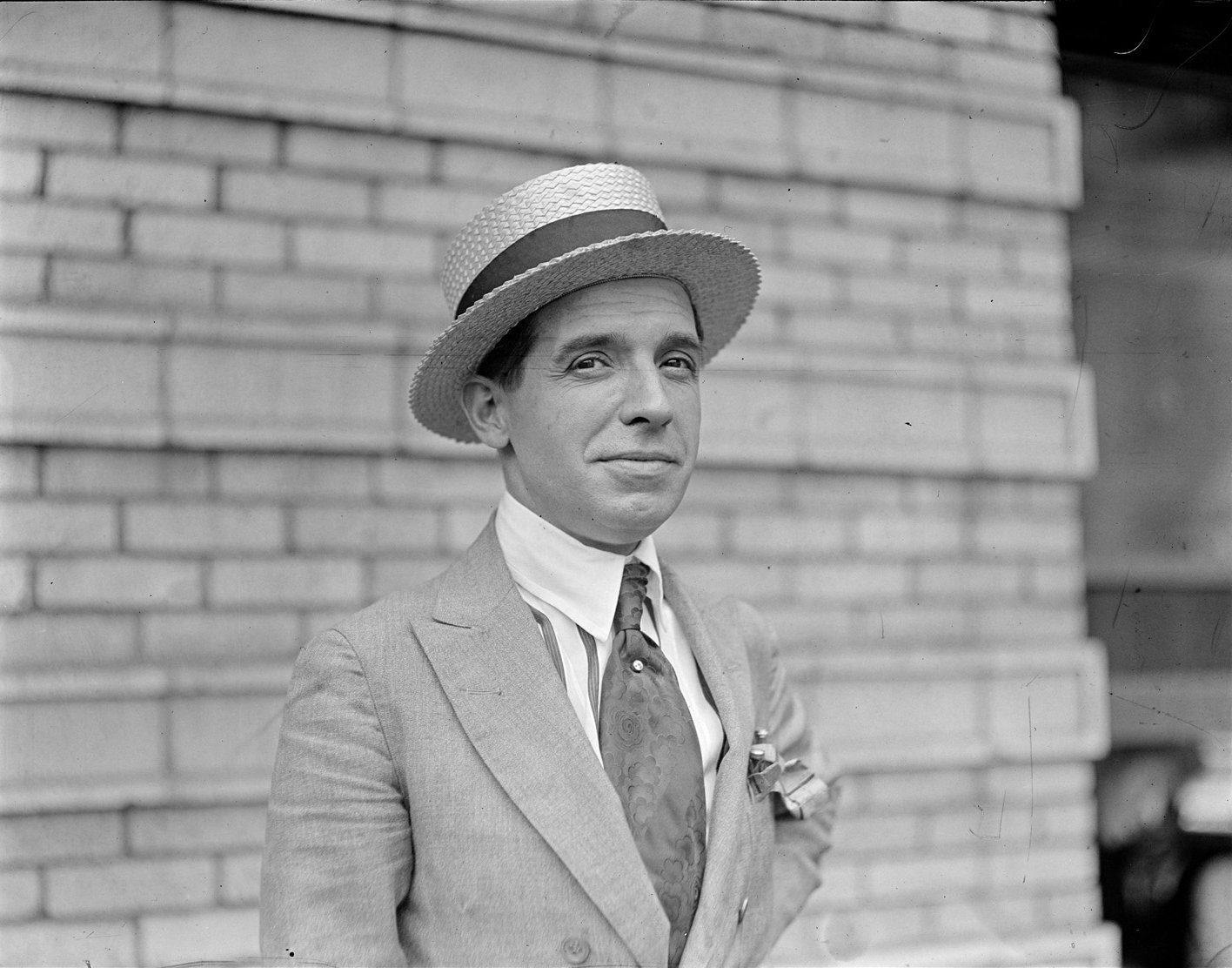 a person in a suit and hat