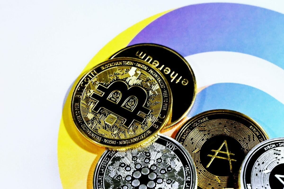 Photo of various cryptocurrency coins, including bitcoin, ether, and litecoin.