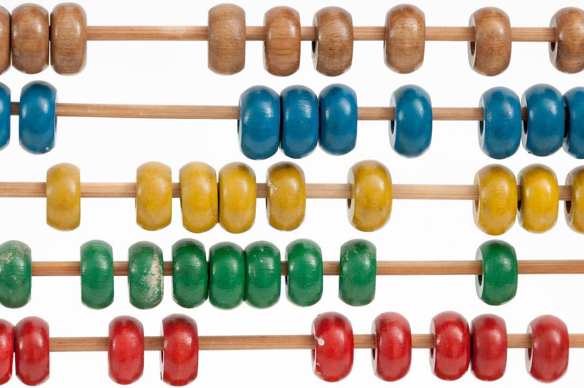 An image of a vibrant abacus, adorned with wooden beads of various colors, used for mathematical calculations.