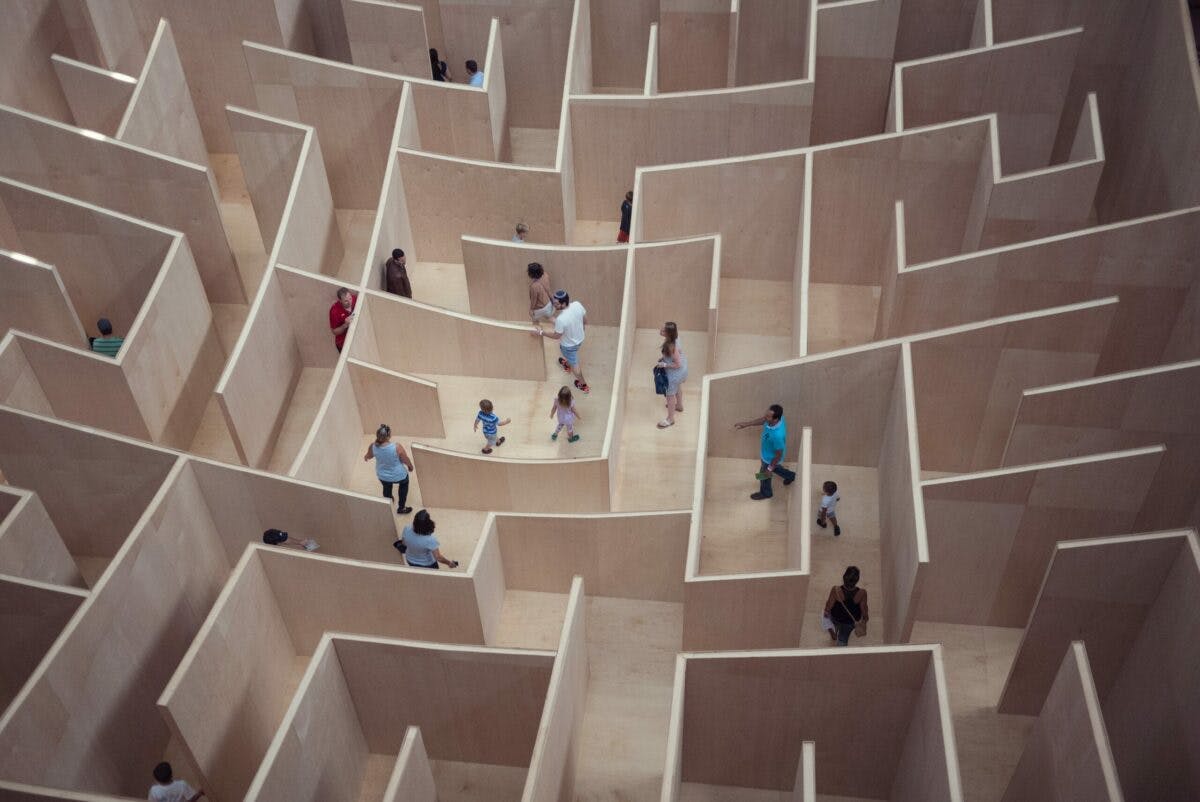People walk wooden block maze.