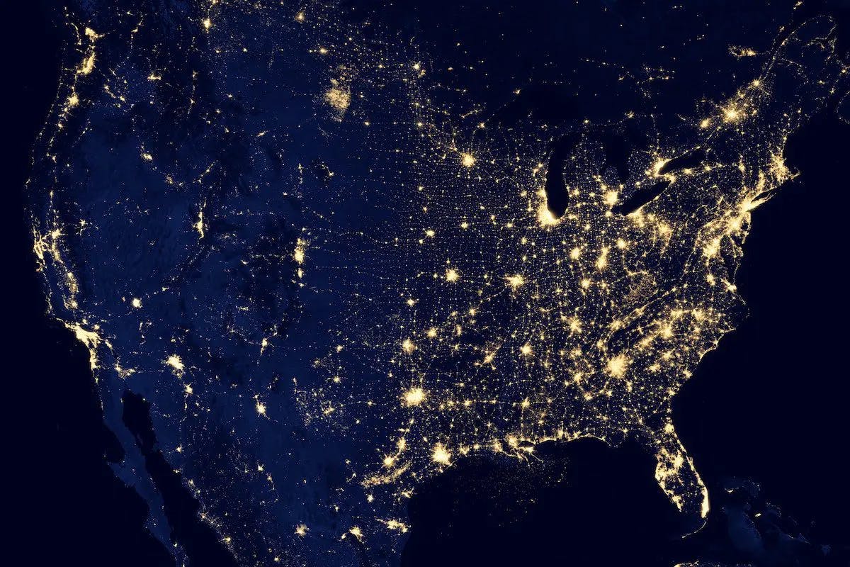 The United States illuminated at night, showcasing its vast urban areas and coastlines, as seen from space.