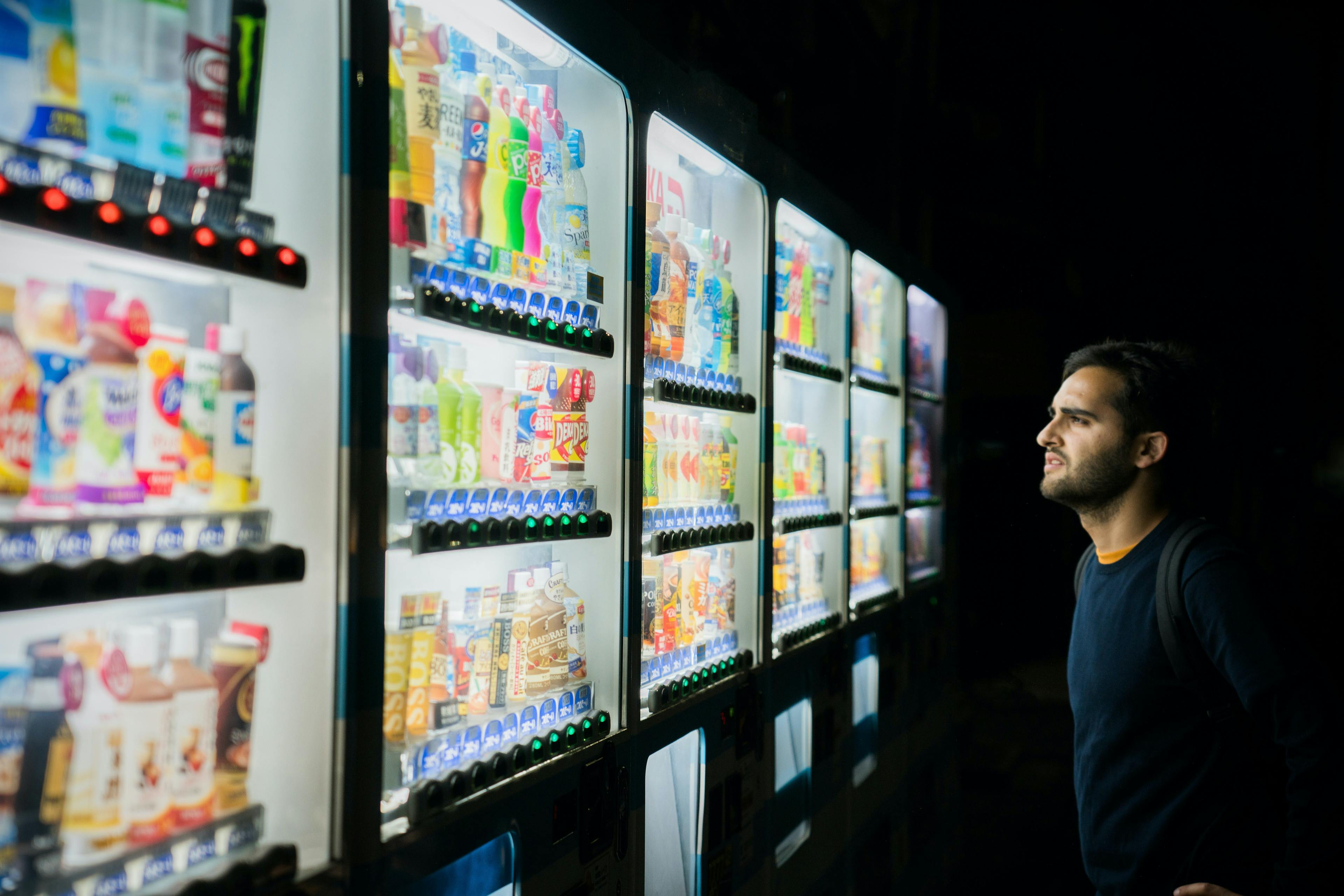 a person looking at a vending machine