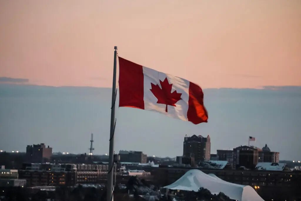 Canada flag overlooking a Canadian city