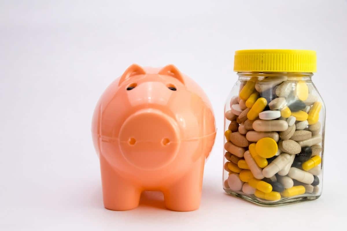 A piggy bank filled with pills, symbolizing financial health and the cost of healthcare.