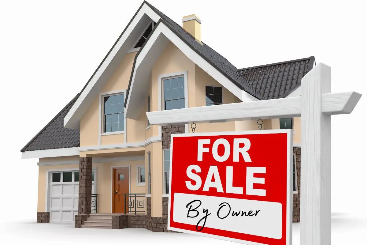 Real estate sign in front of house for sale