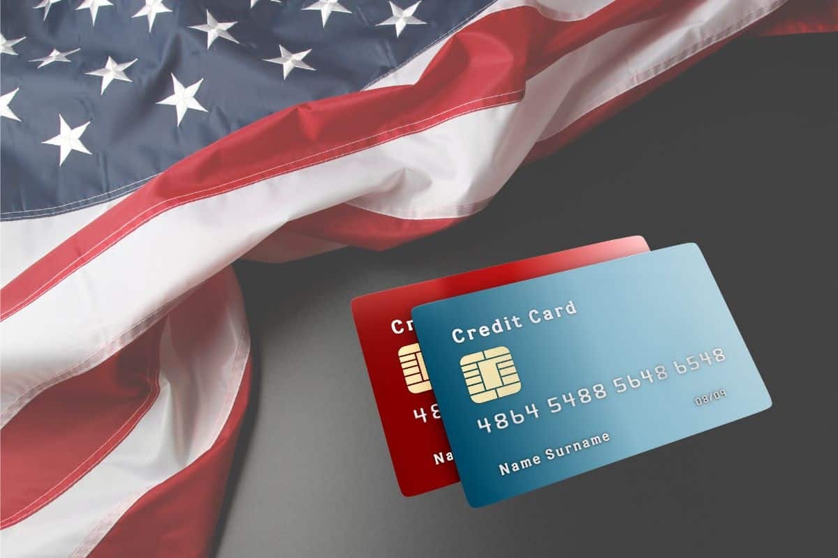 An American flag accompanied by credit cards, symbolizing financial transactions and patriotism.
