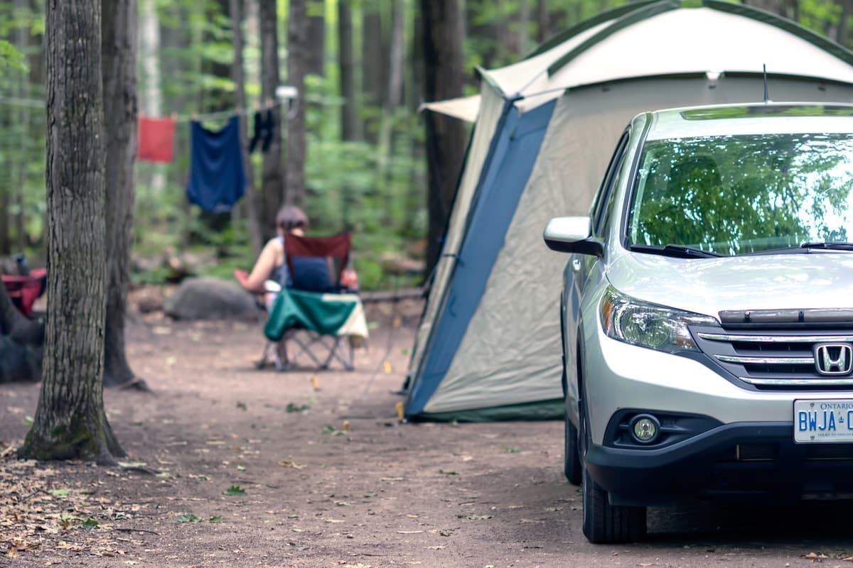 a car parked in front of a tent