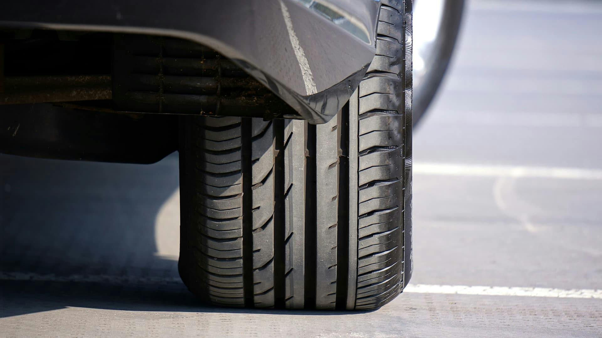A detailed view of a car tire, showcasing its tread pattern and texture, ready to hit the road.