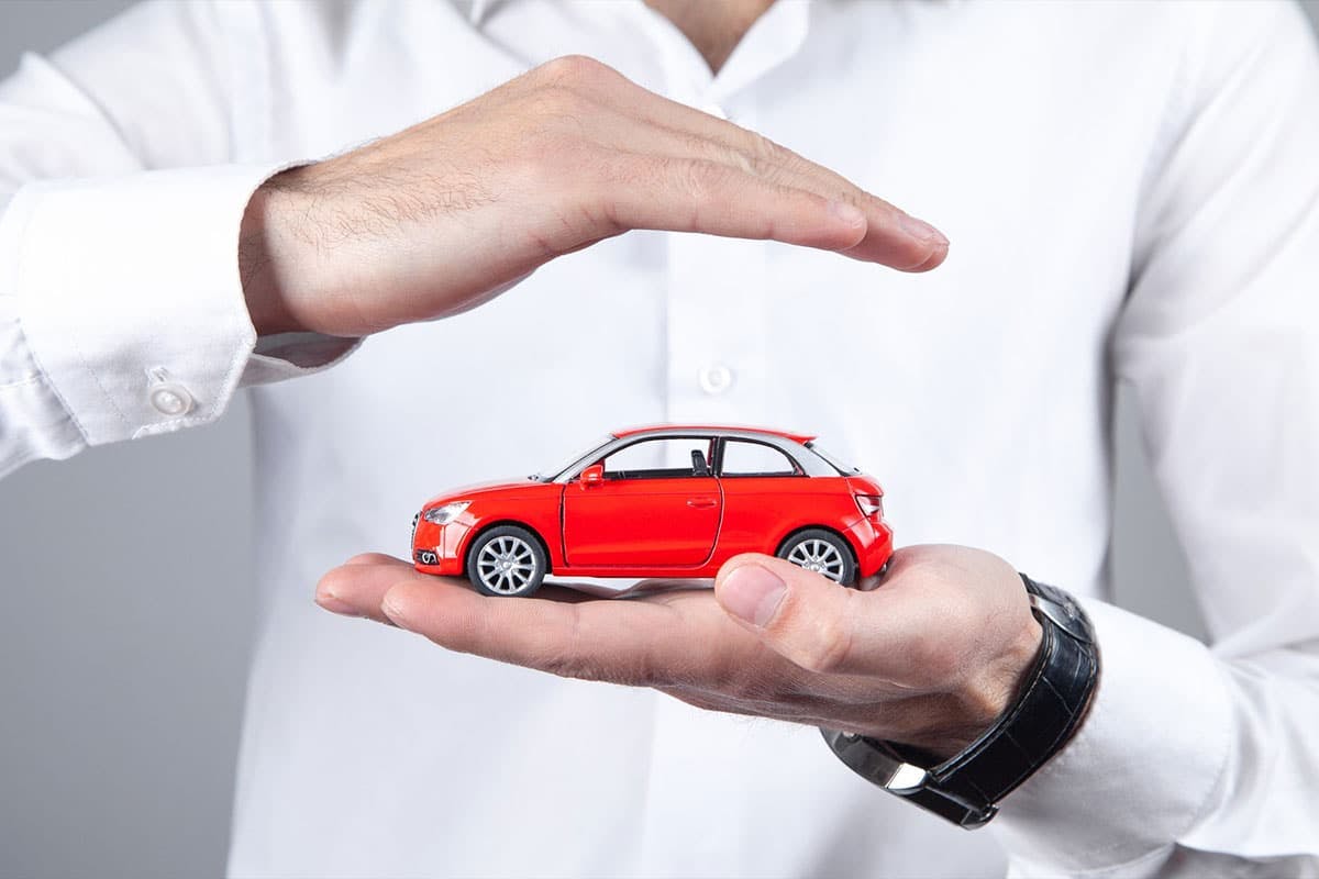 a person holding a toy car