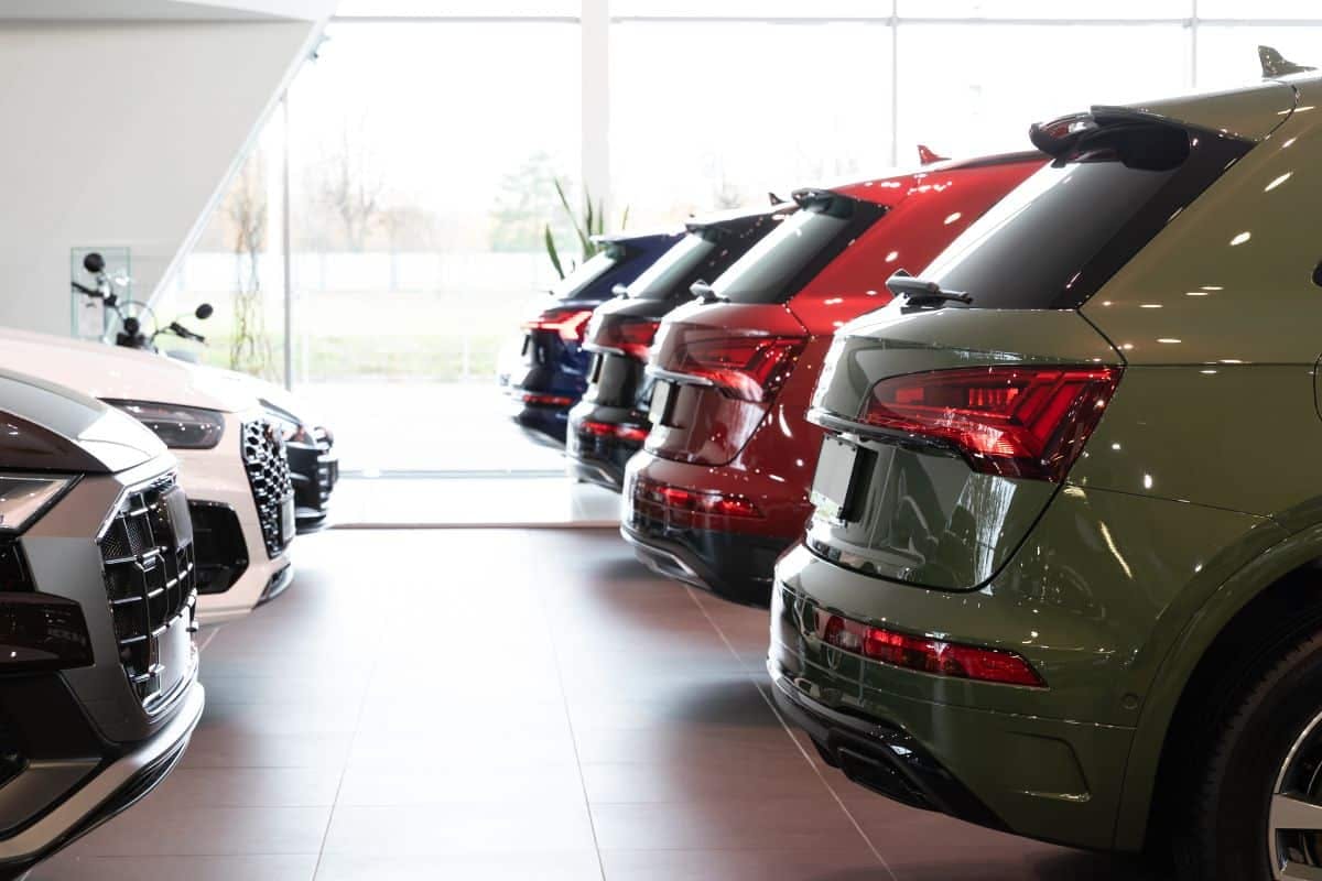 A collection of Audi cars displayed elegantly in a showroom, showcasing their sleek designs and luxurious features.