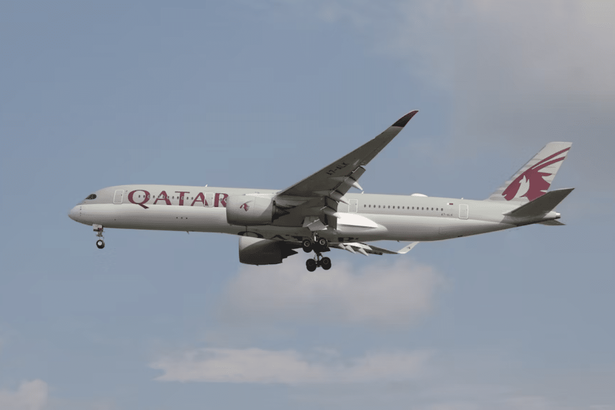 a plane of Qatar Airways flying in the sky