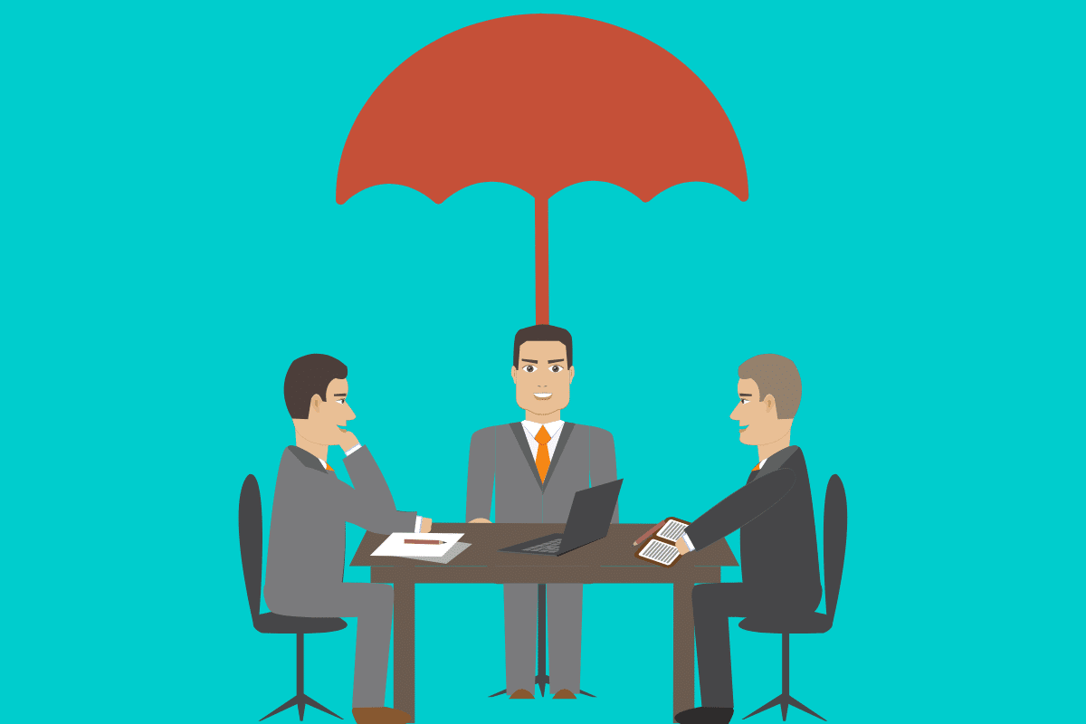 a group of men sitting at a table with a laptop under a red umbrella