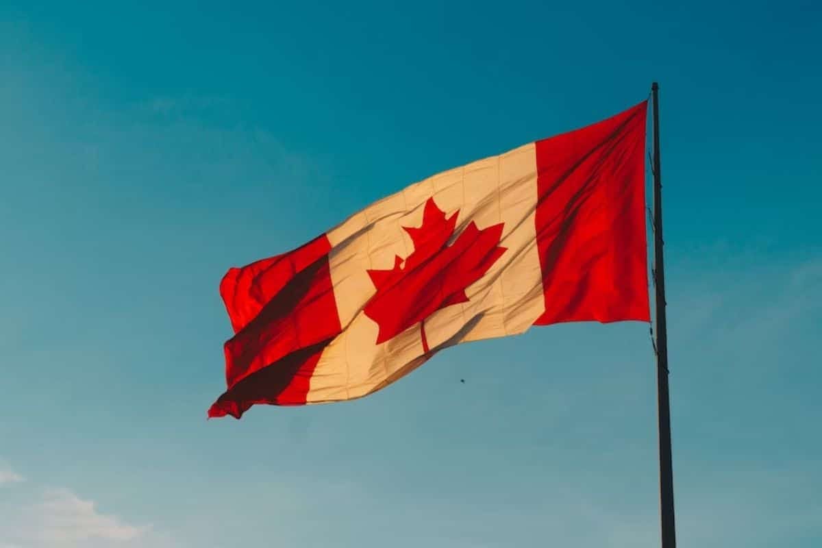 a canadian flag on a pole
