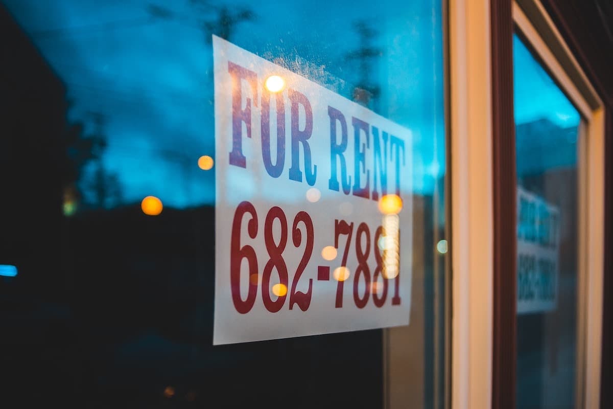 A rental property sign showcased in a window, offering a glimpse of a potential living space.