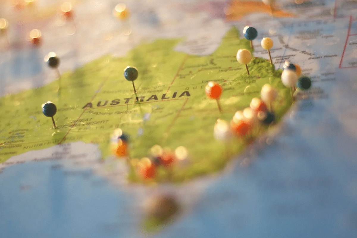 a map guide to moving to Australia with a group of pins on it