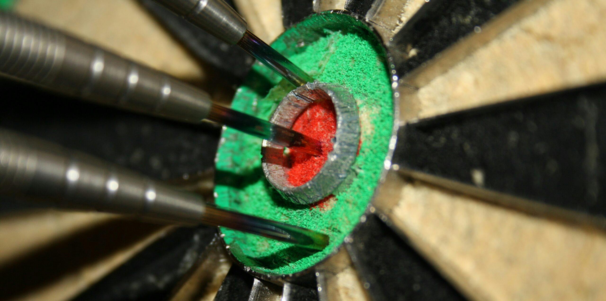 A dart precisely hitting the center of a target, showcasing remarkable accuracy and precision.