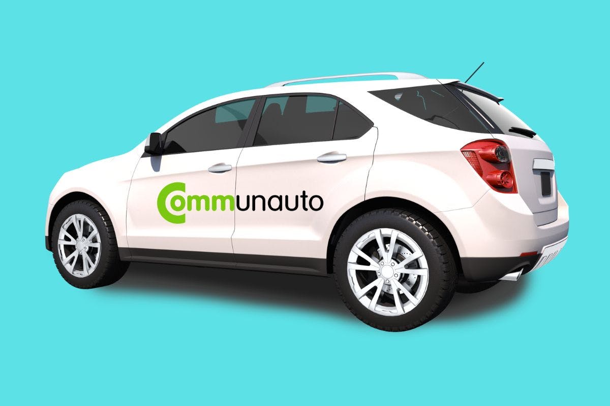 A white car displaying the word "Communauto" on its surface, representing a car-sharing service.